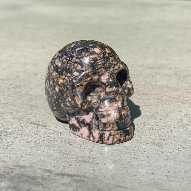 Natural Rhodonite Hand Carved Small Skull A - .24 lbs (2 x 1.25 x 1.5 inches) - Magick Magick.com